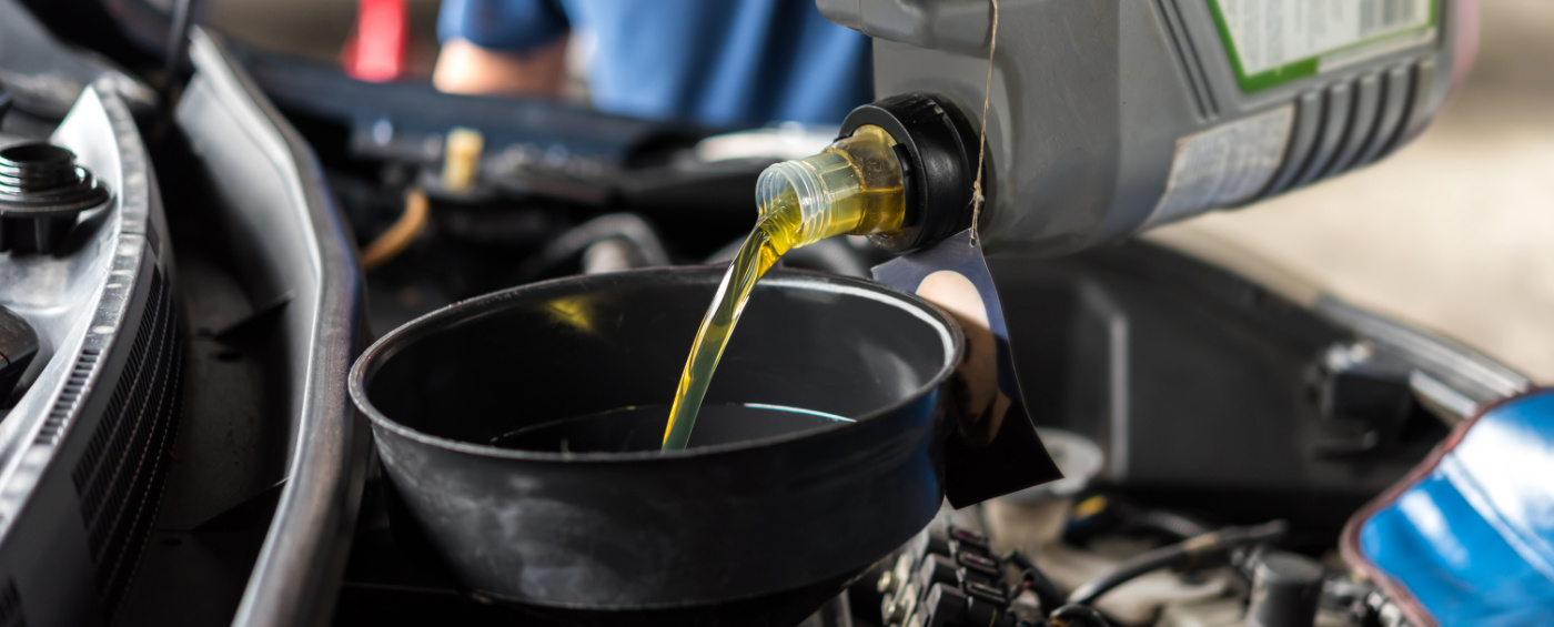 Engine oil being poured into a vehicle - Car Servicing Sawston